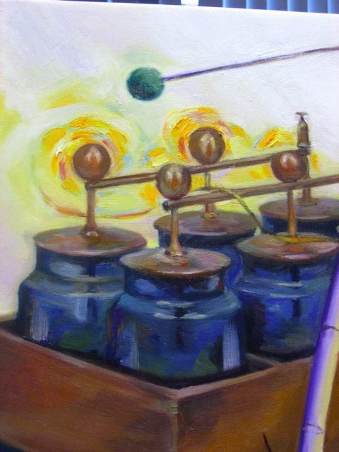 The Leiden jars pay homage to the location where the painting hangs, the Lorentz Institute, which is located in Leiden.  The yellow swirls above the brass wiring charges the viewer&rsquo;s attention.  This yellowish region is inspired by swirling galaxies with Van Gogh flair.  The green ball above the jars is the end of a pendulum.  Many problems in physics reduce to solving harmonic oscillator equations.